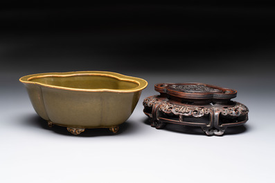 A fine Chinese teadust-glazed quadrifoil jardini&egrave;re with an openworked wooden stand, Yongzheng mark and of the period