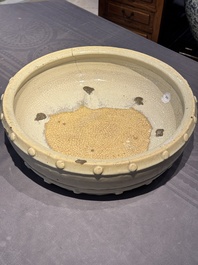 A large Chinese cream-glazed drum-shaped basin, Ming