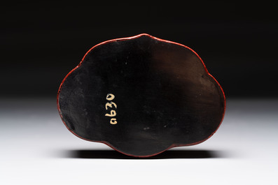 A fine Chinese red cinnabar lacquer ruyi-form 'Ba Man Xian Bao 八蠻獻寶' box and cover, Qianlong