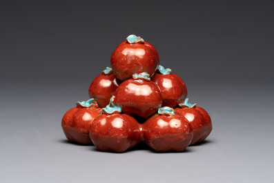 A pair of Chinese polychrome 'persimmons' groups on wooden stands, 19th C.