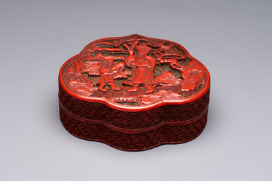 A fine Chinese red cinnabar lacquer ruyi-form 'Ba Man Xian Bao 八蠻獻寶' box and cover, Qianlong