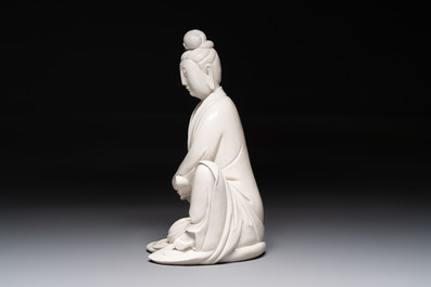 A rare and elegant Chinese Dehua blanc de Chine Guanyin on a wooden stand, Transitional period
