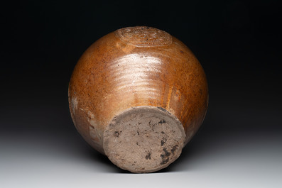 A large brown-glazed stoneware bellarmine jug, 17th C.