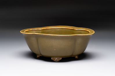 A fine Chinese teadust-glazed quadrifoil jardini&egrave;re with an openworked wooden stand, Yongzheng mark and of the period