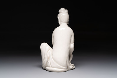 A rare and elegant Chinese Dehua blanc de Chine Guanyin on a wooden stand, Transitional period