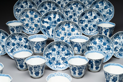 A collection of 18 Japanese blue and white cups and 17 saucers with figural and floral design, 19th C.