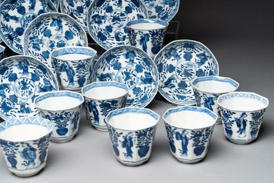 A collection of 18 Japanese blue and white cups and 17 saucers with figural and floral design, 19th C.