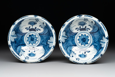 A pair of small blue and white Dutch Delft bowls, two tripod salts and a condiment dish, 17/18th C.