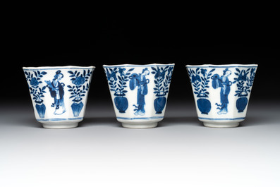 A collection of 18 Japanese blue and white cups and 17 saucers with figural and floral design, 19th C.