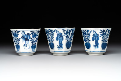 A collection of 18 Japanese blue and white cups and 17 saucers with figural and floral design, 19th C.