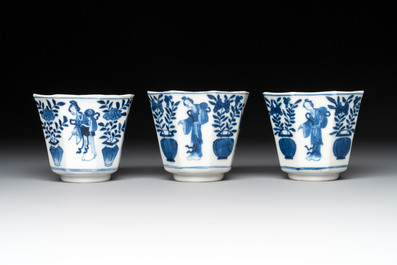 A collection of 18 Japanese blue and white cups and 17 saucers with figural and floral design, 19th C.
