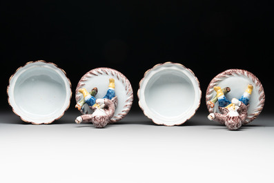 A pair of polychrome Dutch Delft fluting-children-topped butter tubs and covers, 18th C.