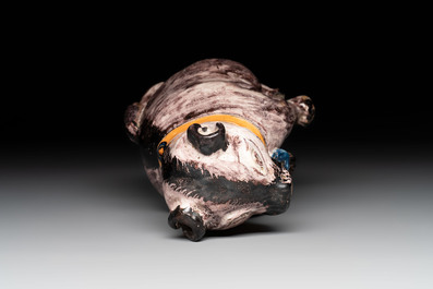 A polychrome Brussels faience model of a dog, 18th C.
