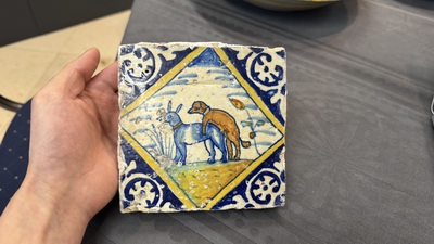A polychrome Dutch Delft maiolica 'mating dogs' diamond tile, late 16th C.