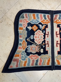Two Tibetan saddle rugs with Buddhist lions and antiquities, 19th C.