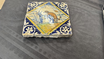 A polychrome Dutch Delft maiolica 'mating dogs' diamond tile, late 16th C.
