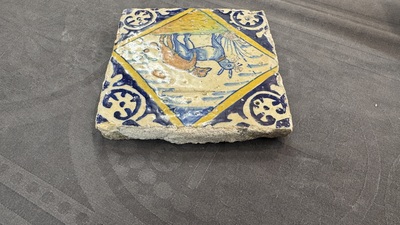 A polychrome Dutch Delft maiolica 'mating dogs' diamond tile, late 16th C.