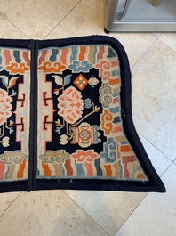 Two Tibetan saddle rugs with Buddhist lions and antiquities, 19th C.