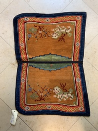 Two Tibetan saddle rugs with Buddhist lions and antiquities, 19th C.