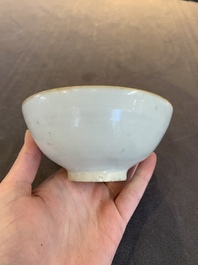 Four Chinese white-glazed saucers and three bowls, Yuan/Ming