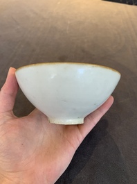 Four Chinese white-glazed saucers and three bowls, Yuan/Ming