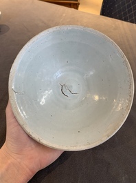Four Chinese white-glazed saucers and three bowls, Yuan/Ming