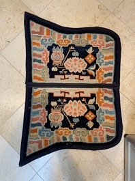 Two Tibetan saddle rugs with Buddhist lions and antiquities, 19th C.