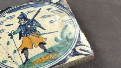 A polychrome Dutch Delft maiolica 'soldier' medallion tile, late 16th C.