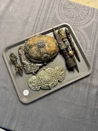 Four Tibetan bronze and wooden phurbas, a 'kapala' or skull-bowl and two silver ornaments, 19th C.