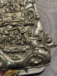 Four Tibetan bronze and wooden phurbas, a 'kapala' or skull-bowl and two silver ornaments, 19th C.