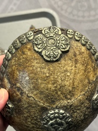 Four Tibetan bronze and wooden phurbas, a 'kapala' or skull-bowl and two silver ornaments, 19th C.