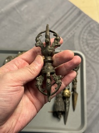 Four Tibetan bronze and wooden phurbas, a 'kapala' or skull-bowl and two silver ornaments, 19th C.