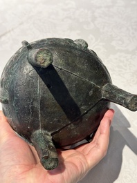 A Chinese archaic bronze tripod food vessel with 'taotie' design, 'ding 鼎', Western Zhou