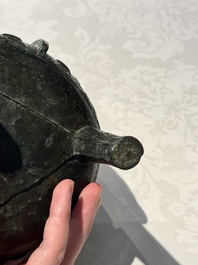 A Chinese archaic bronze tripod food vessel with 'taotie' design, 'ding 鼎', Western Zhou