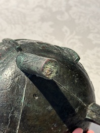 A Chinese archaic bronze tripod food vessel with 'taotie' design, 'ding 鼎', Western Zhou