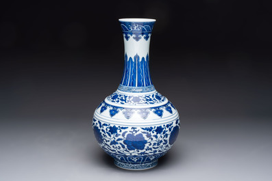 A Chinese blue and white 'flower scroll' bottle vase, Xuantong mark, 20th C.