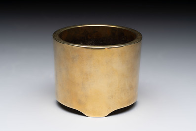 A Chinese bronze cylindrical tripod censer, Xuande mark, 18th C.