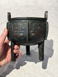 A Chinese archaic bronze tripod food vessel with 'taotie' design, 'ding 鼎', Western Zhou