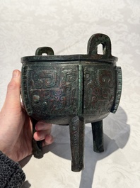 A Chinese archaic bronze tripod food vessel with 'taotie' design, 'ding 鼎', Western Zhou