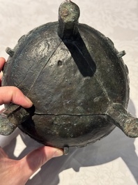A Chinese archaic bronze tripod food vessel with 'taotie' design, 'ding 鼎', Western Zhou