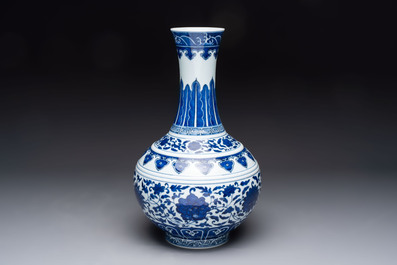 A Chinese blue and white 'flower scroll' bottle vase, Xuantong mark, 20th C.