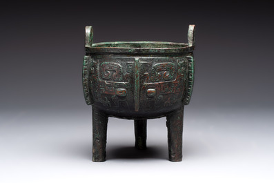 A Chinese archaic bronze tripod food vessel with 'taotie' design, 'ding 鼎', Western Zhou