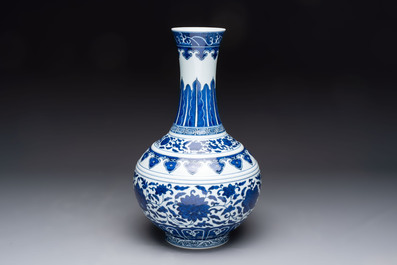 A Chinese blue and white 'flower scroll' bottle vase, Xuantong mark, 20th C.