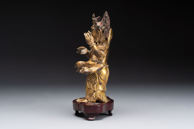 A Sino-Tibetan gilt-bronze figure of White Mahakala on wooden stand, 18th C.