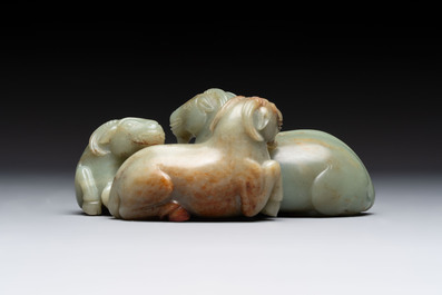 A Chinese celadon jade group of three goats on wooden stand, 19/20th C.