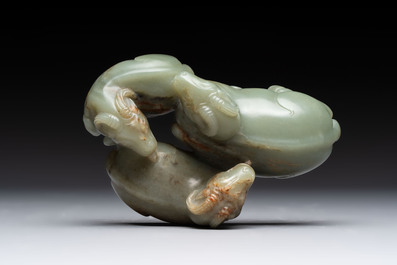 A Chinese celadon jade group of three goats on wooden stand, 19/20th C.