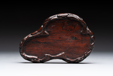 A Chinese celadon jade group of three goats on wooden stand, 19/20th C.