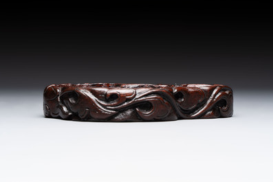 A Chinese celadon jade group of three goats on wooden stand, 19/20th C.