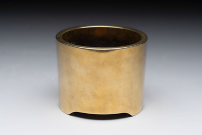 A Chinese bronze cylindrical tripod censer, Xuande mark, 18th C.