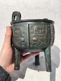 A Chinese archaic bronze tripod food vessel with 'taotie' design, 'ding 鼎', Western Zhou